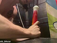 Gay fetish scene with a twink deepthroating a horse cock toy