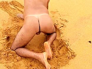 A hot gay Latino guy shows off his ass on the beach in this video
