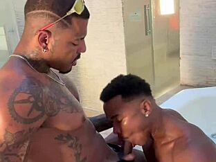 Two large black penises in a motel bathroom scene